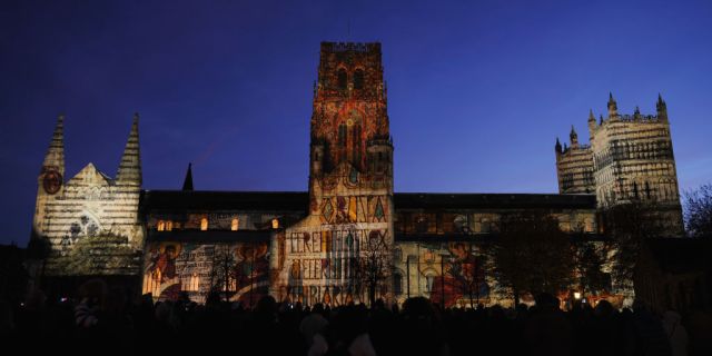 Illuminated manuscripts from the Lindisfarne Gospels are projected onto the side of Durham Cathedral. Credit: Ian Forsyth/Getty 