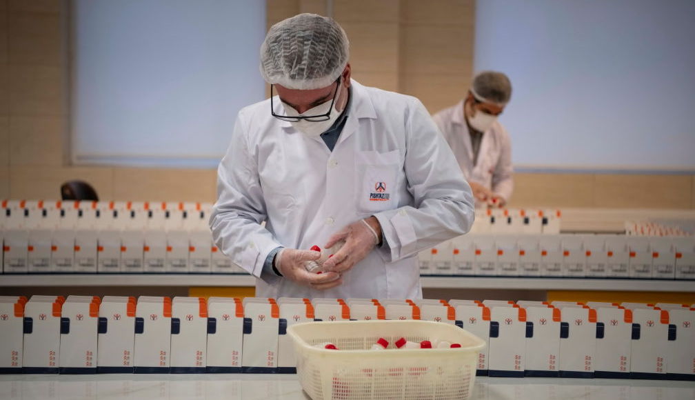 Medical firm staff work in a lab on coronavirus testing kits (Photo by Majid Saeedi/Getty Images)