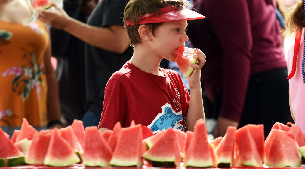 A boy enjoys a slice of watermelon at the City of Winter Park, Florida. Credit: Getty Images