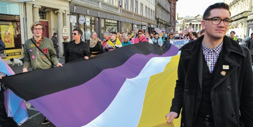 Protesters in Scotland hold a non-binary flag. Credit: Getty