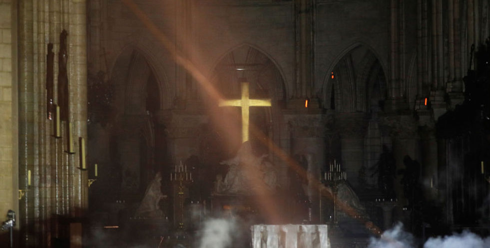 A cross shining through the wreckage in Notre Dame Cathedral. Credit: Getty