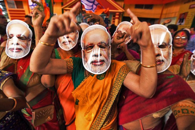 Indian Bharatiya Janata Party (BJP) supporters wearing masks of Indian Prime Minister Narendra Modi. Photo by BIJU BORO/AFP via Getty Images