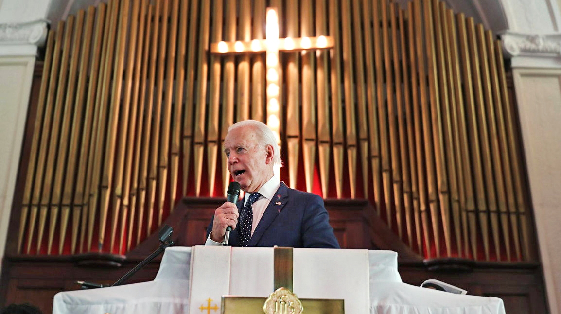 President Biden is caught between two worlds