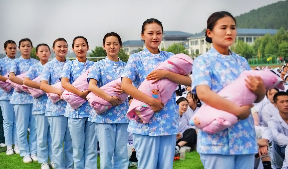 Nursing students show baby care skills. Credit: Getty