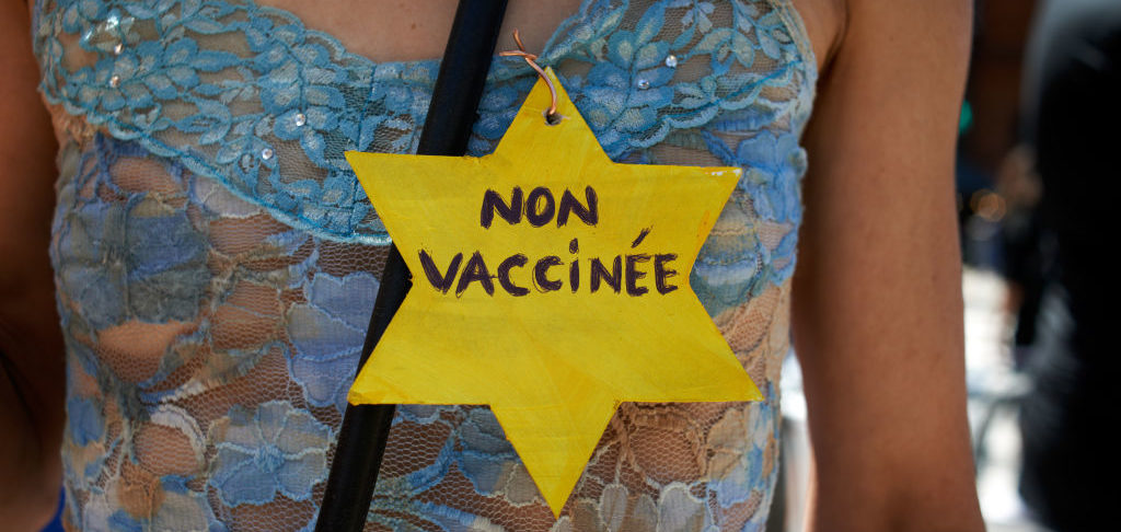 A woman holds a yellow star reading 'non vaccinated'. July 17th 2021 (Photo by Alain Pitton/NurPhoto via Getty Images)