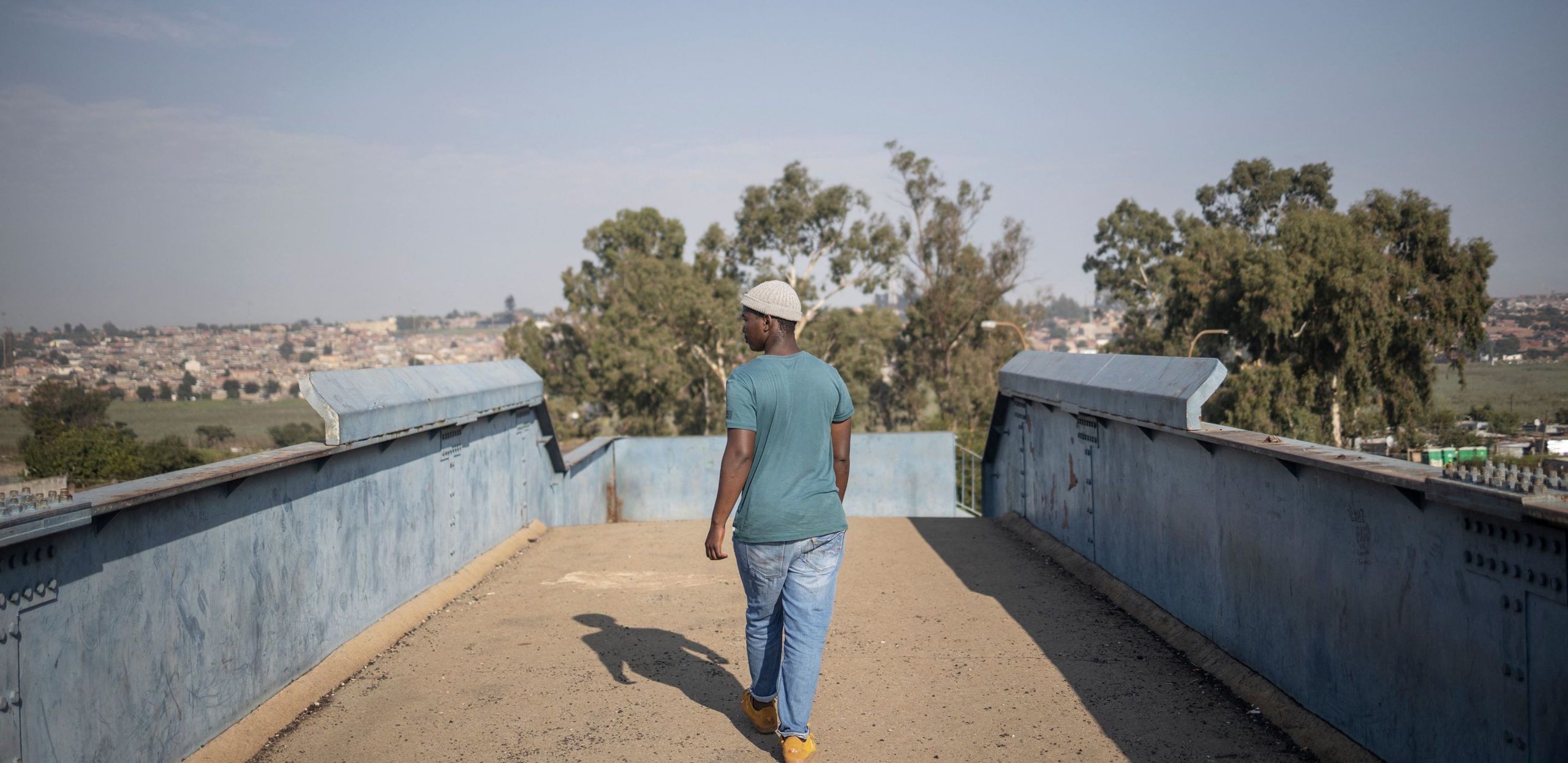 A resident walks over Kliptown train station in Soweto, Guateng. Credit: Getty