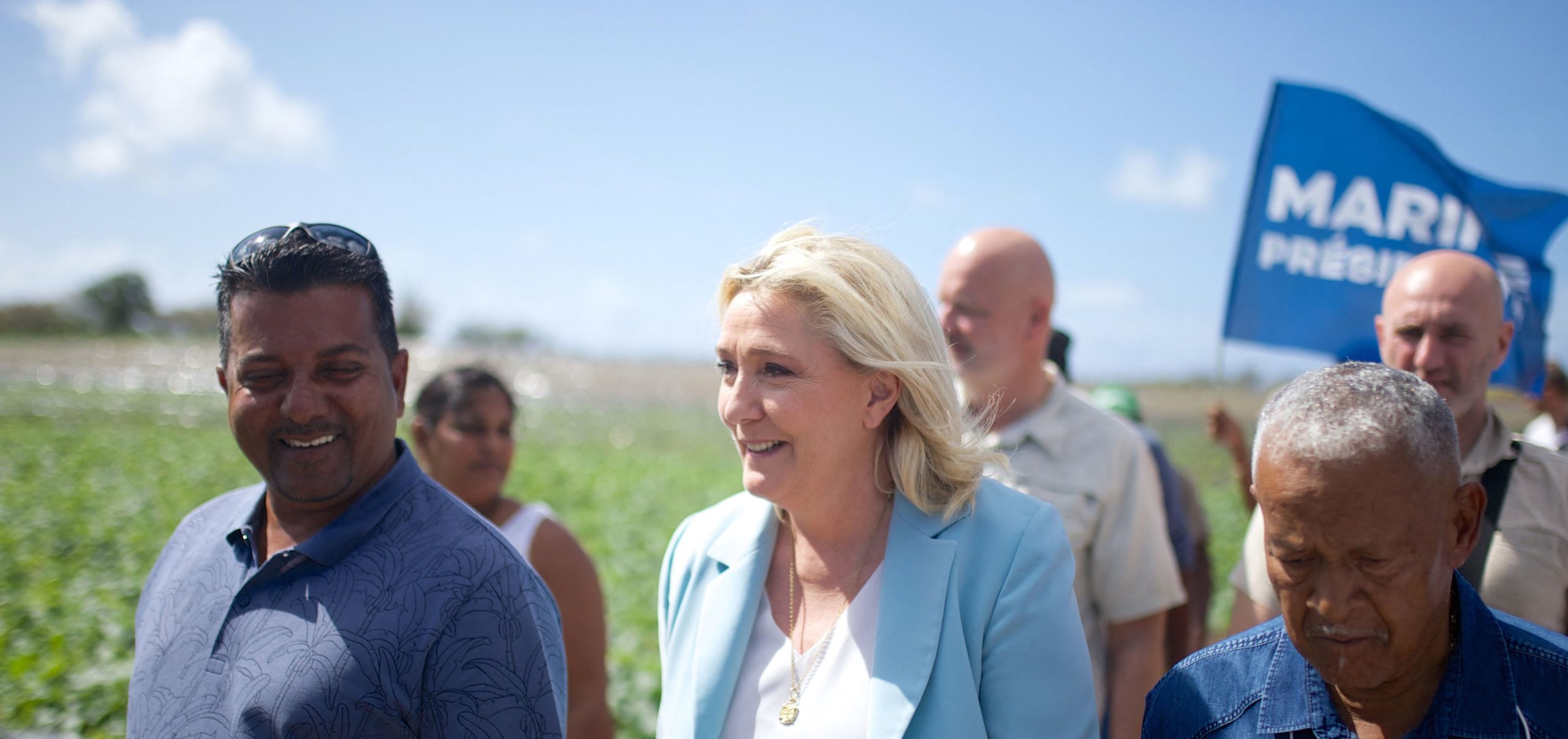 Marine Le Pen (C) speaks with a farmer in Guadeloupe. Credit: Getty