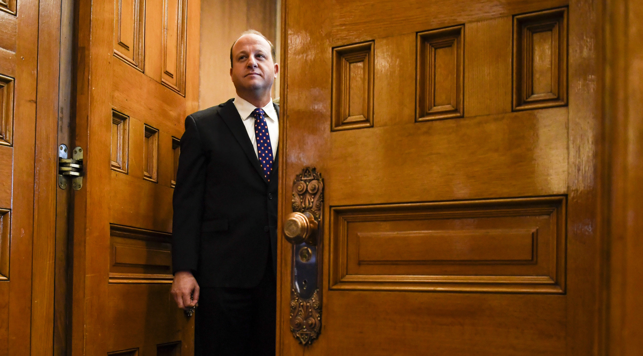 Jared Polis stands in his office before his inauguration. Credit: Getty