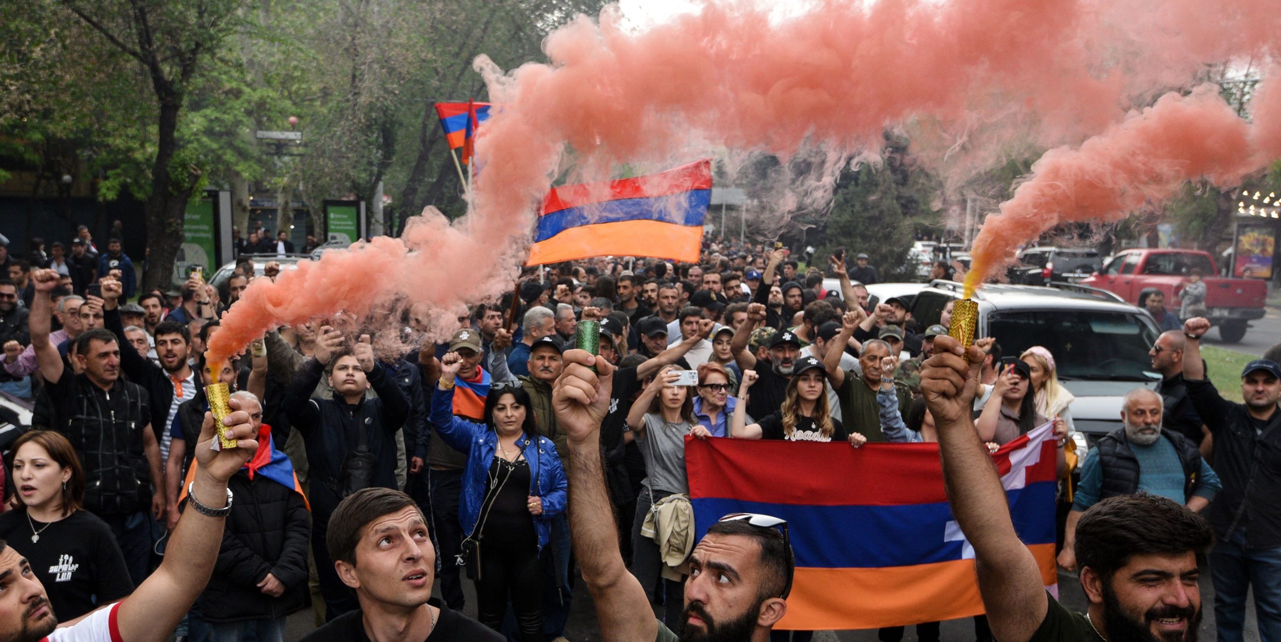 Protesters hold Armenian and Nagorno-Karabakh republic national flags. Credit: Getty