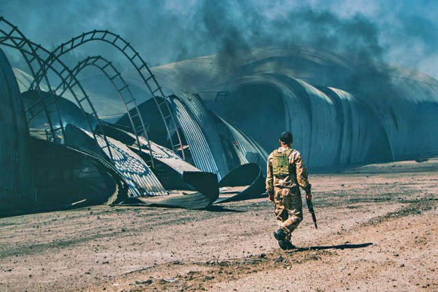 A Ukrainian soldier patrols a wheat silo (Lara Hauser/SOPA Images/LightRocket via Getty Images)