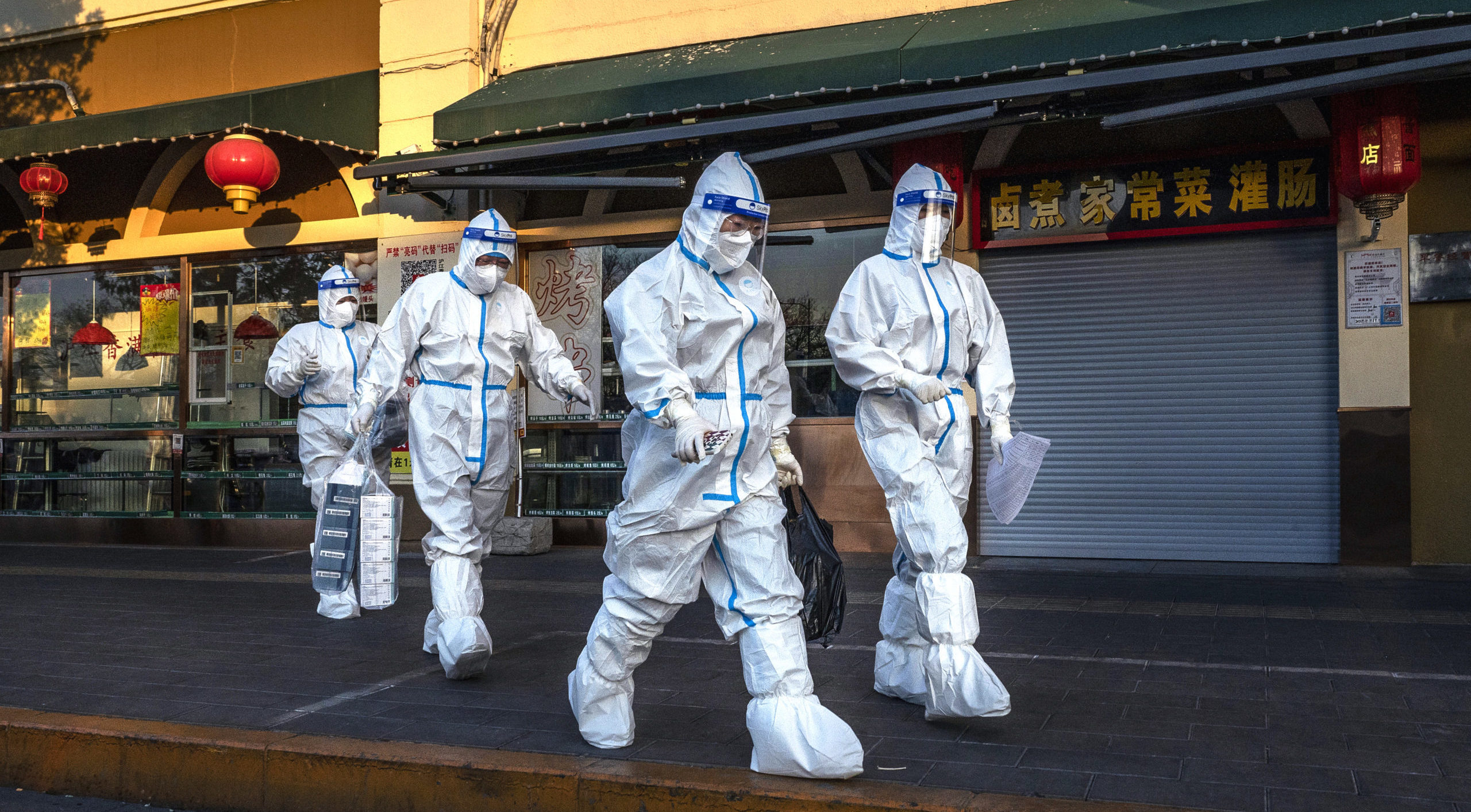 Pandemic workers in Beijing in December (Kevin Frayer/Getty Images)