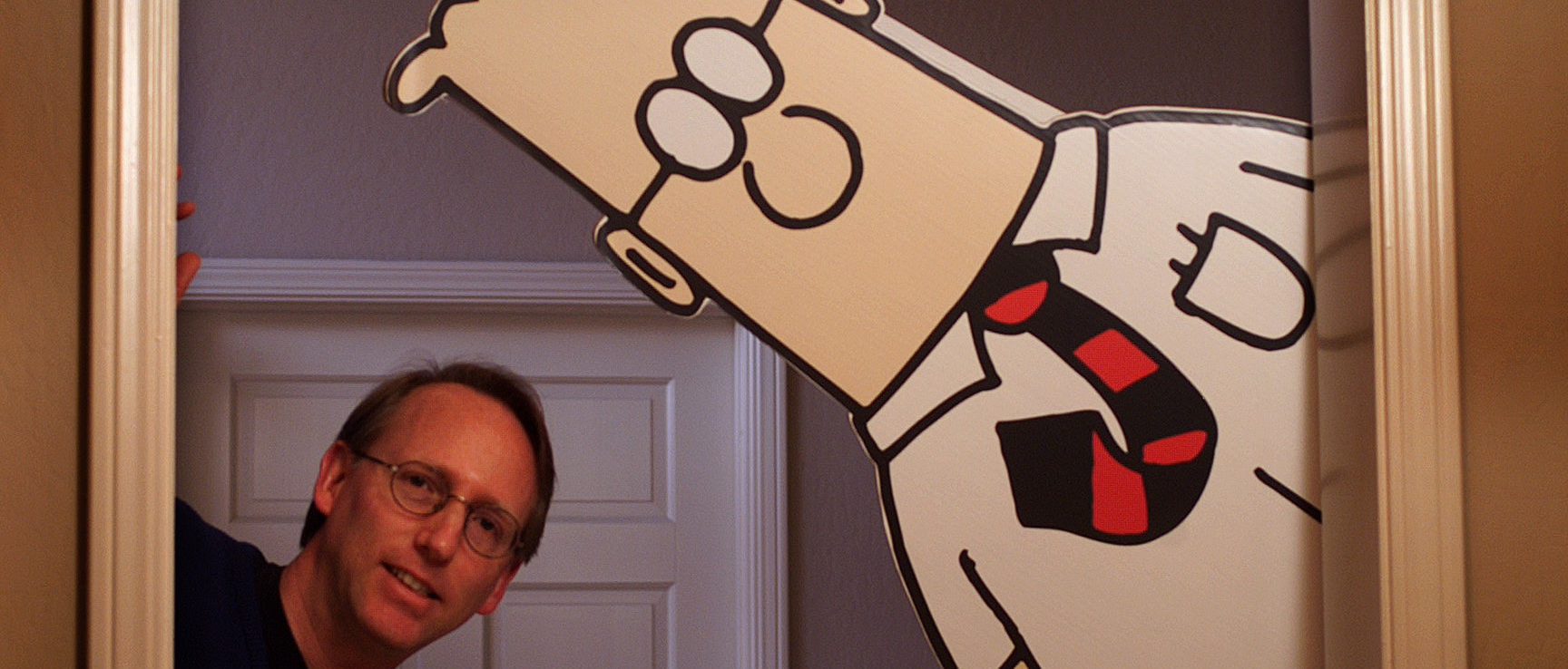 Scott Adams poses with his creation. Credit: Getty.