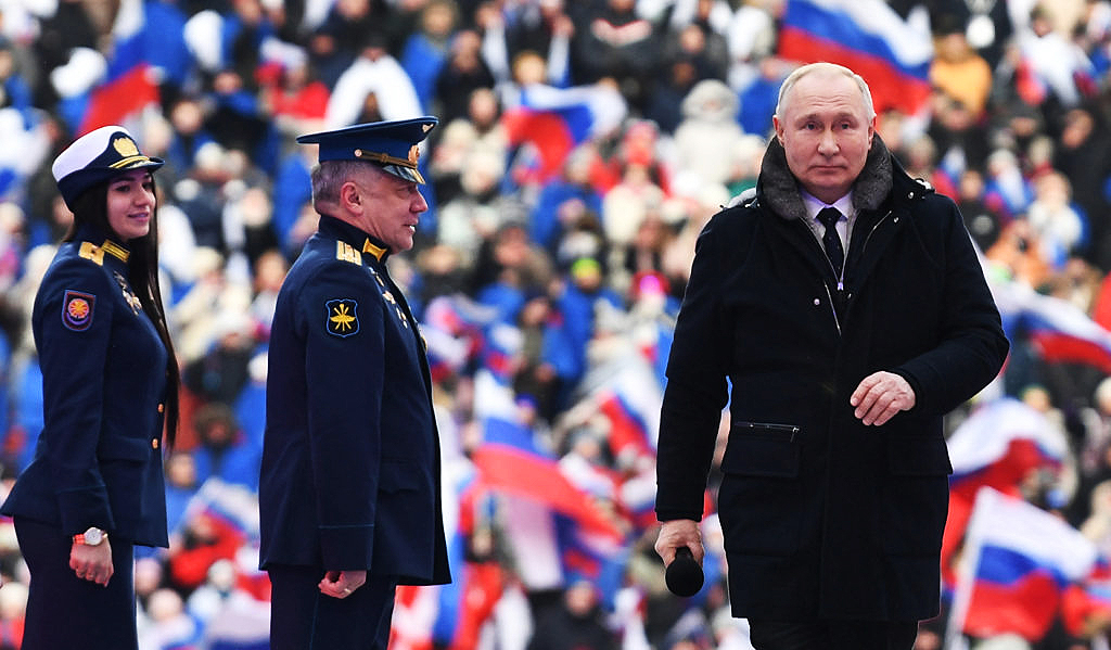 Vladimir Putin attends a patriotic concert in Moscow yesterday. Credit: Getty.