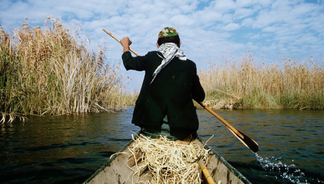 A Marsh Arab, paddling his own canoe. Credit: Nik Wheeler/Corbis via Getty Images