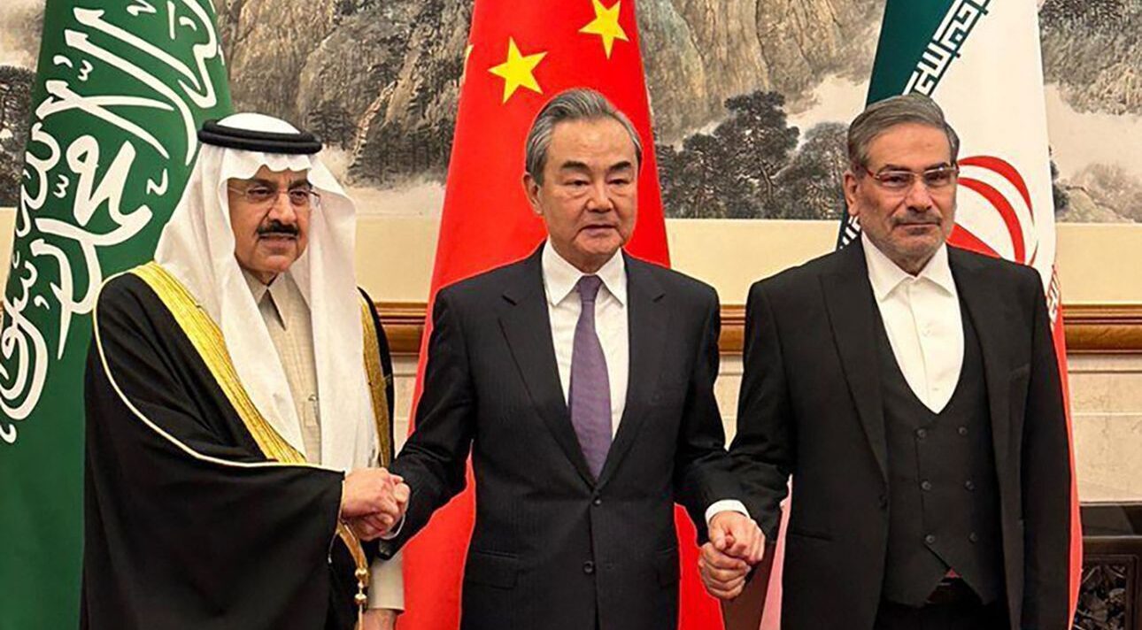 Chinese diplomat Wang Yi between Saudi Arabia's Musaad al-Aiban and Iran's Ali Shamkhani. 
