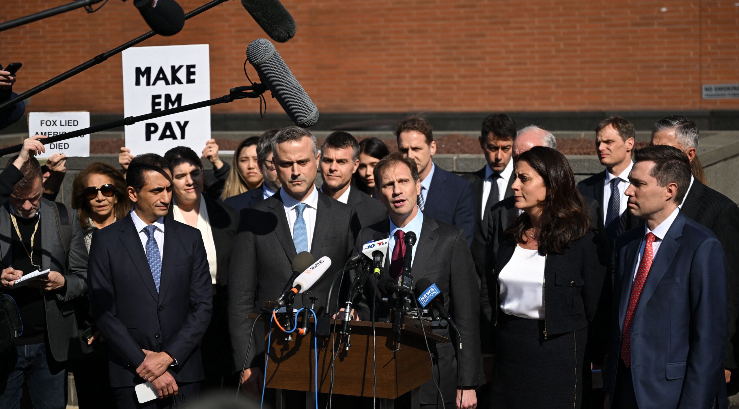 The Dominion Voting Systems legal team celebrate their victory. Credit: Getty