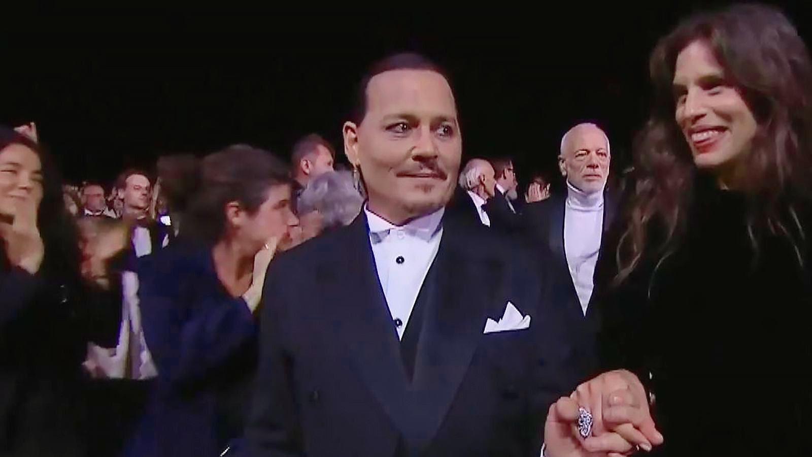 Johnny Depp watches his film receive a seven-minute standing ovation on the opening night at Cannes