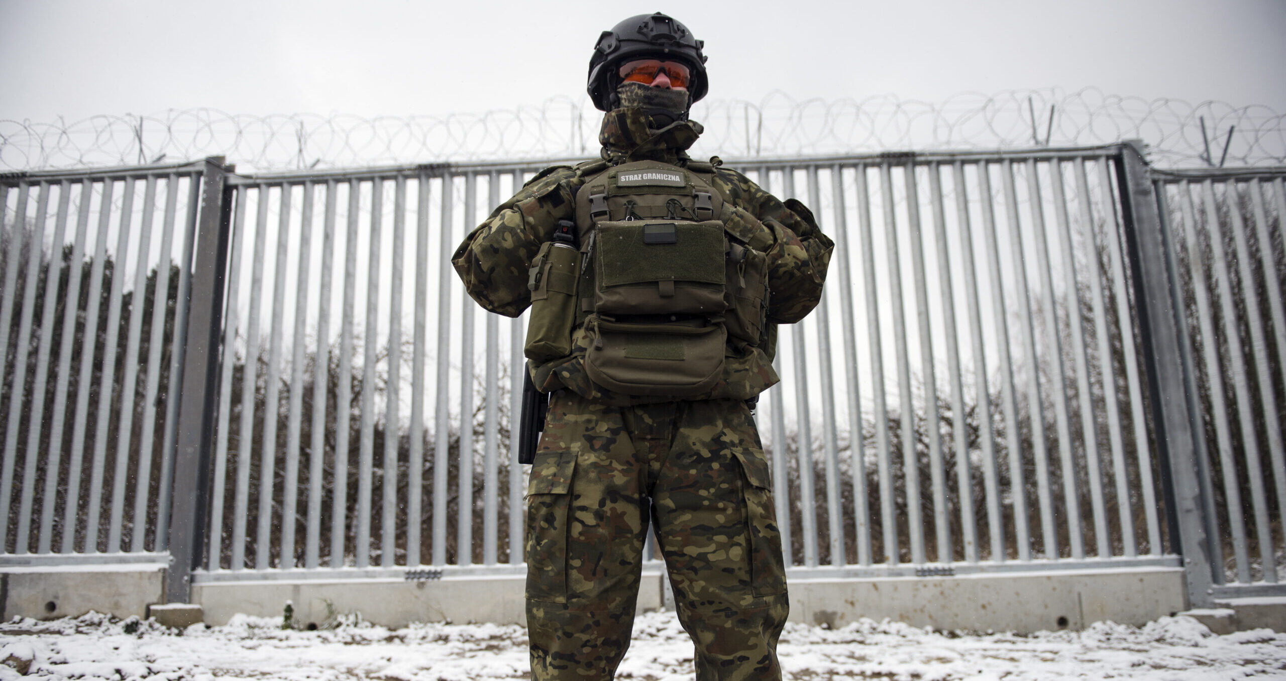A guard mans the border wall dividing Poland from Belarus. Credit: Getty