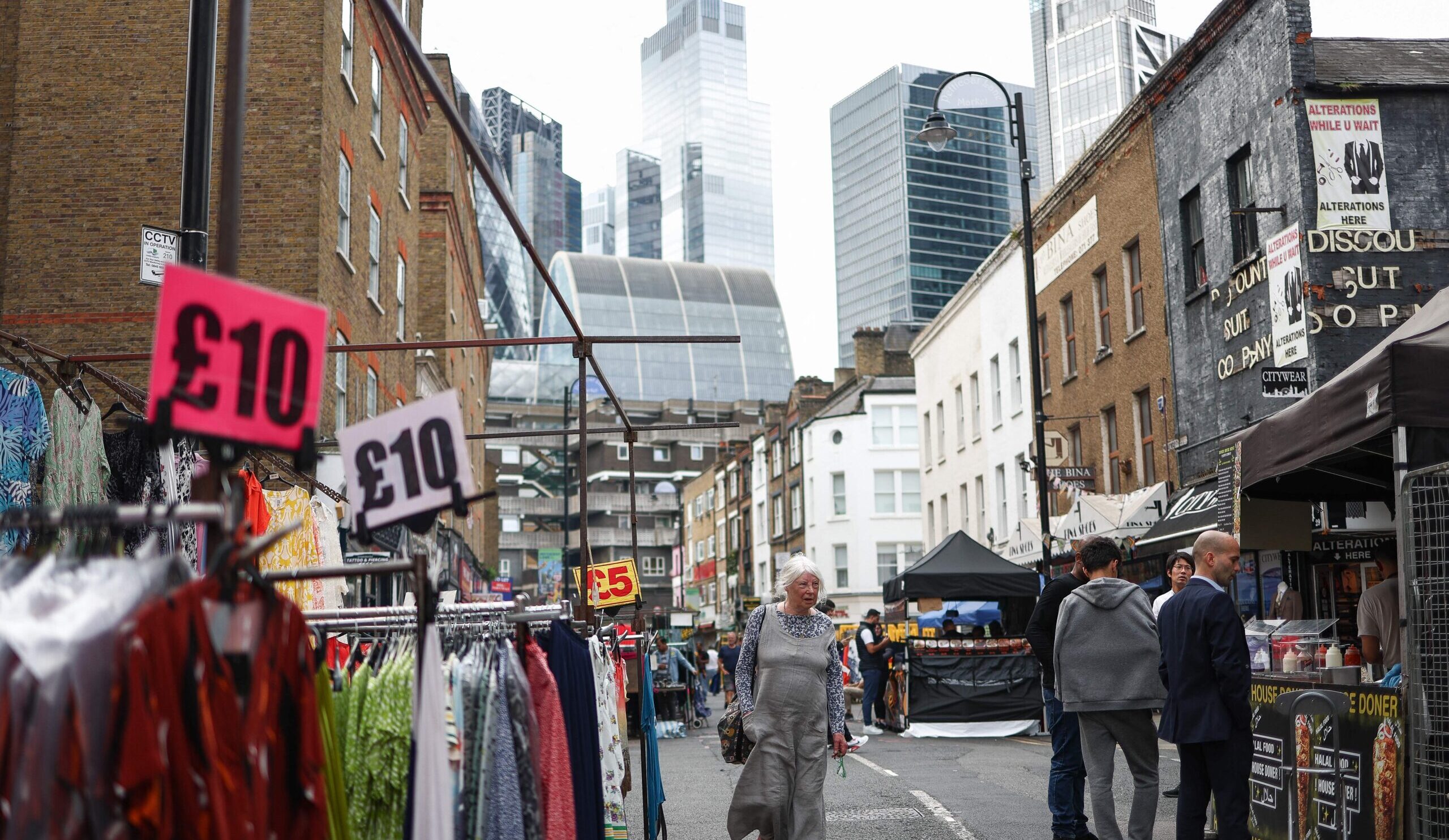 Shoppers browse market stalls against the backdrop of the City of London financial district. Credit: Getty
