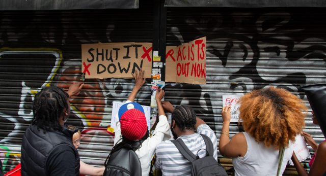 Protesters outside Peckham Hair and Cosmetics shop yesterday. Credit: Getty 