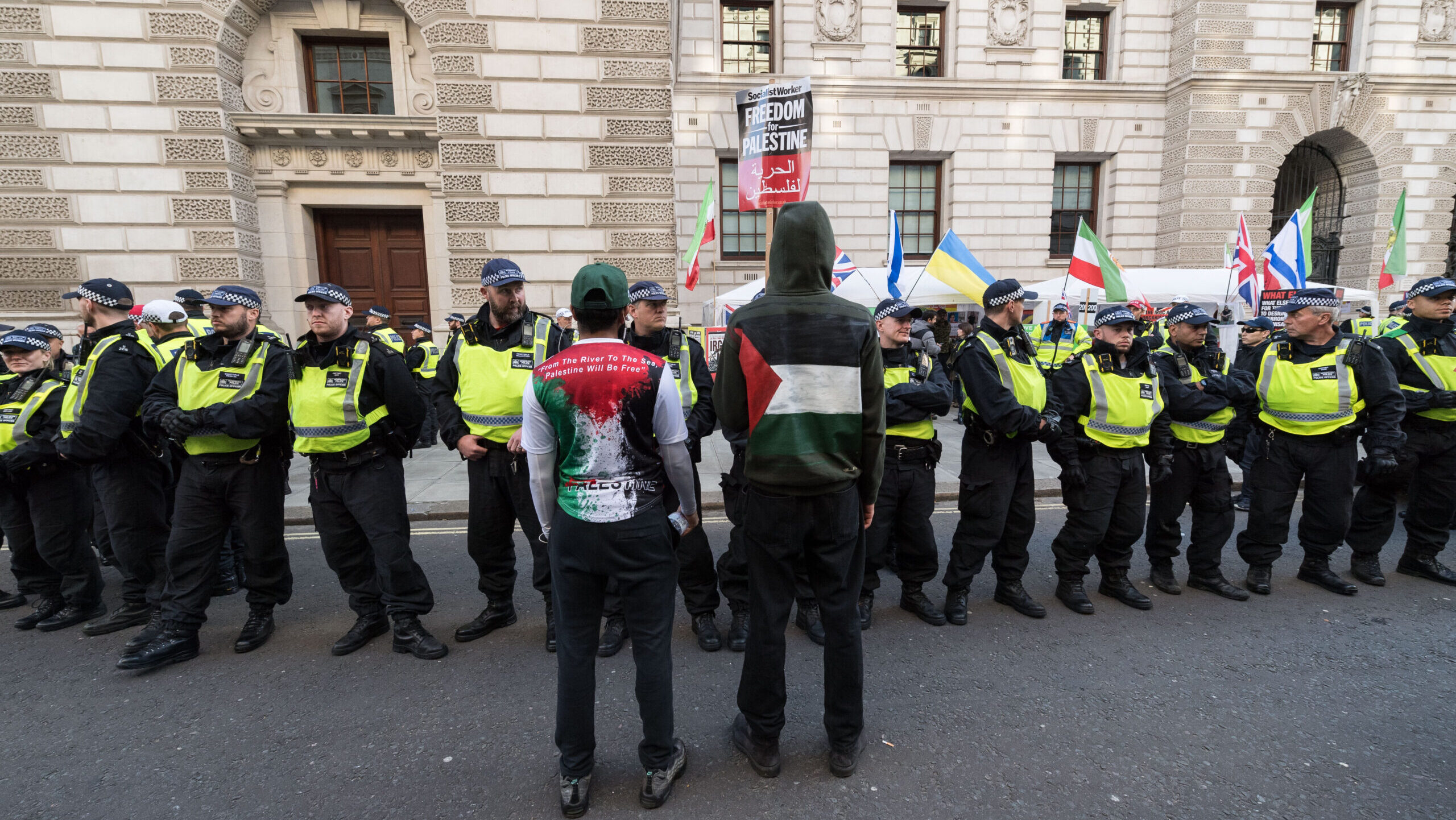 Police stand between pro-Palestinian and pro-Israeli protestors in central London this month. Credit: Getty 