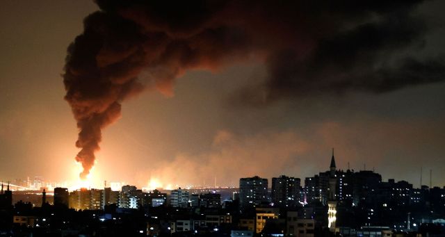 Smoke billows from an oil facility in the southern Israeli city of Ashkelon (MOHAMMED ABED/AFP via Getty Images)