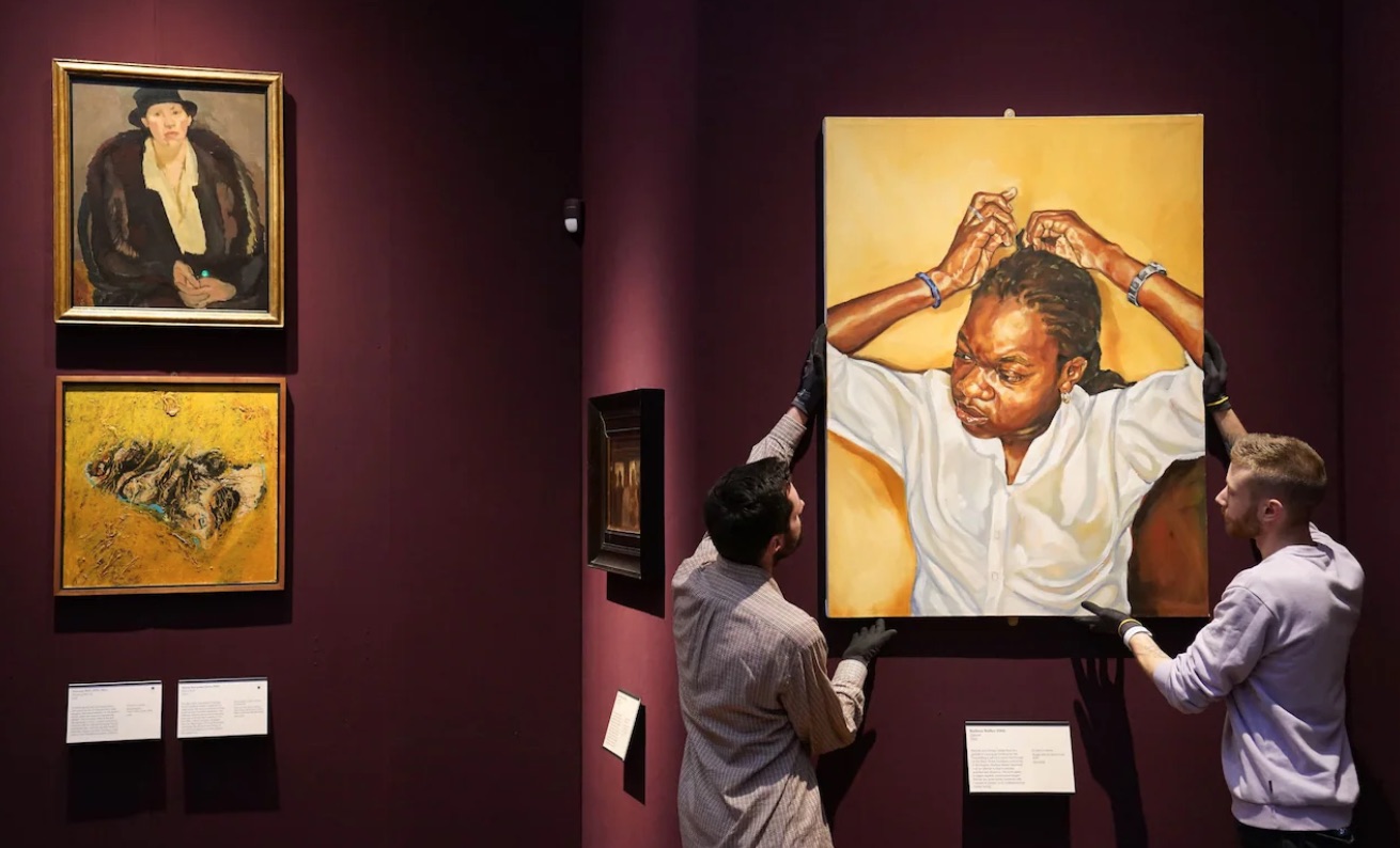 Fitzwilliam gallery technicians rehang Zipporah by Barbara Walker. Credit: Joe Giddens/PA