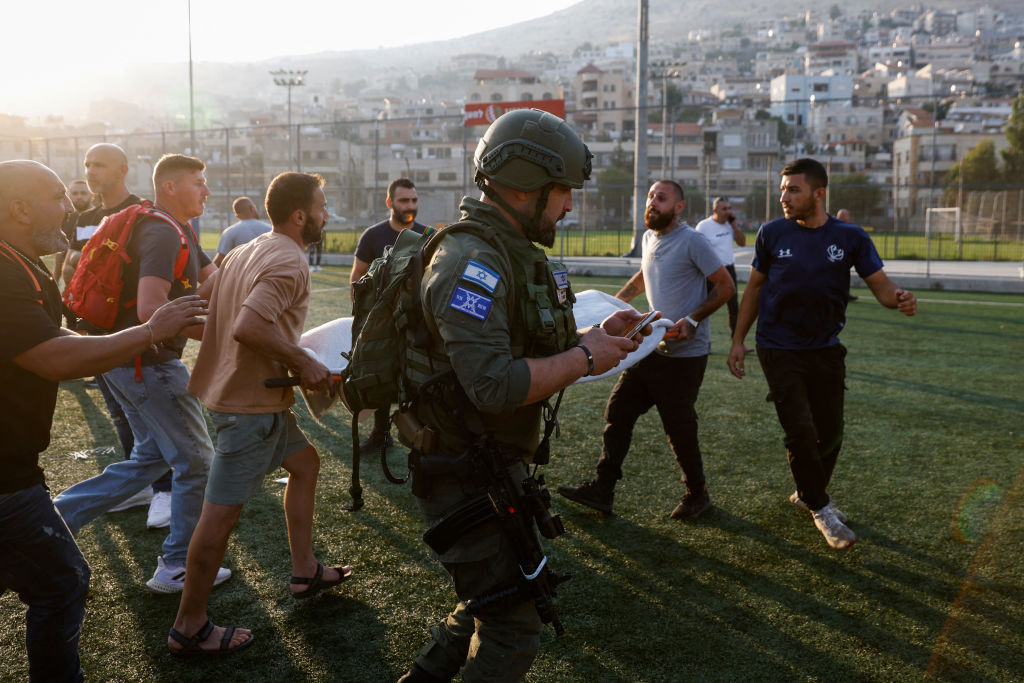 Israeli security forces and medics transport casualties from the site of Saturday's strike in Majdal Shams. Credit: Getty