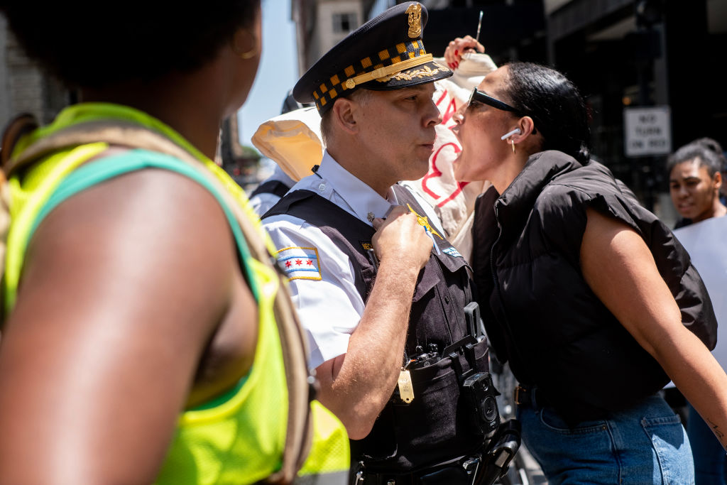 A demonstrator confronts police in Chicago during a march to protest the killing of Sonya Massey. Credit: Getty