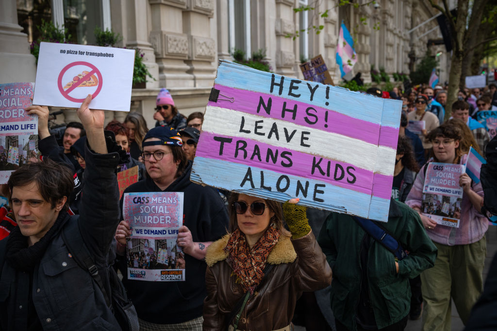 Activists protest the NHS ban of puberty blockers earlier this year. Credit: Getty