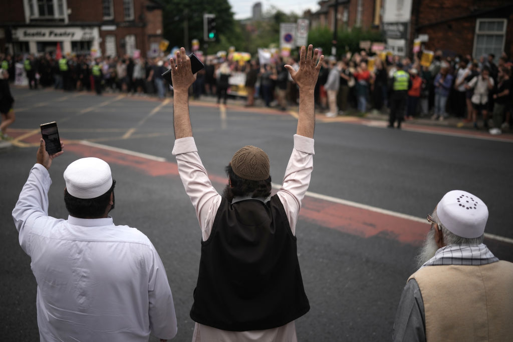 Three muslim men gesture as anti-racism counter protesters begin to assemble in the city centre ahead of a potential anti-immigration protest on August 7, 2024 in Sheffield. Credit: Getty