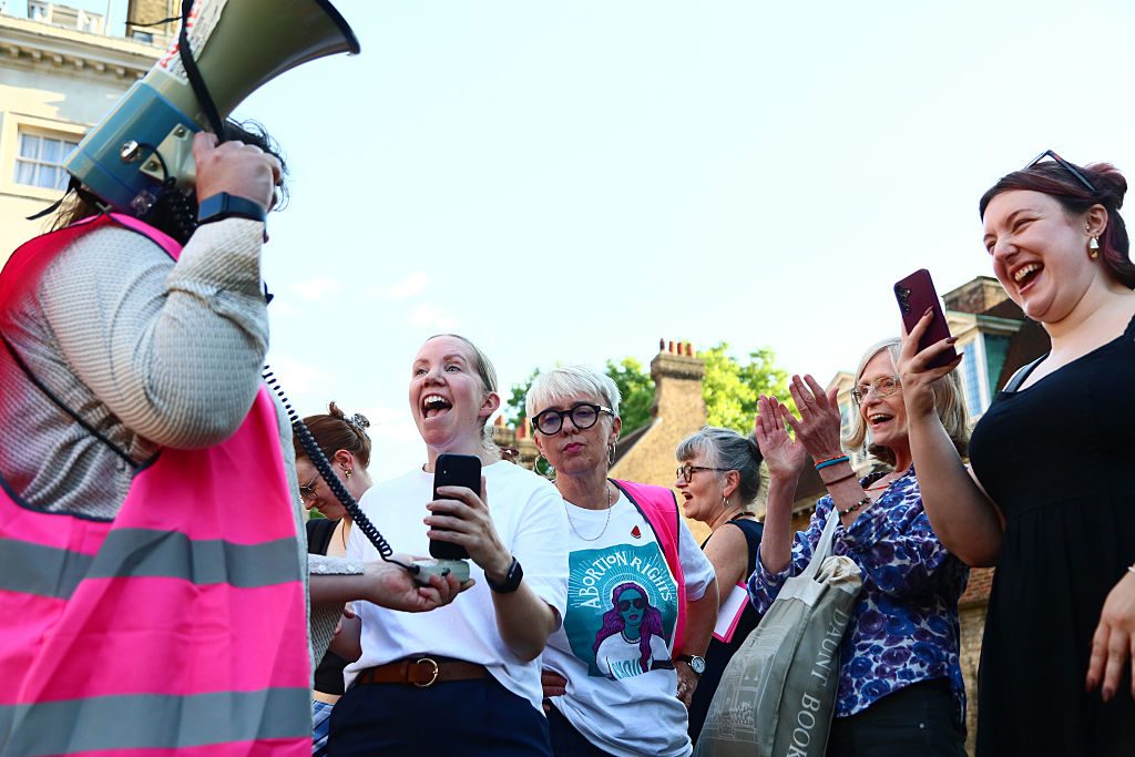Pro-choice campaigners celebrate outside Parliament following yesterday's vote. Credit: Getty